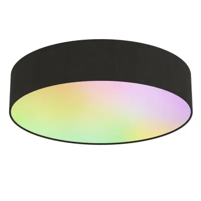 A black cylindrical ceiling light with a soft, multicolored glow on the underside, featuring shades of pink, green, and yellow.